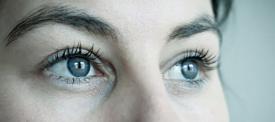 closeup of a woman's blue eyes with eye makeup looking away