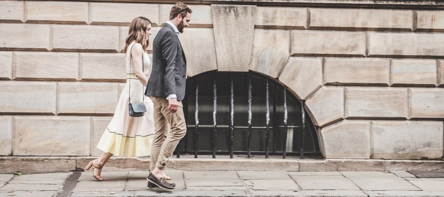 man and woman in casual office dress walking on the street