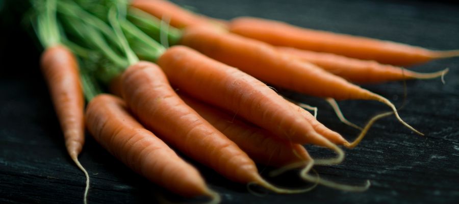 carrots lying on dark surface
