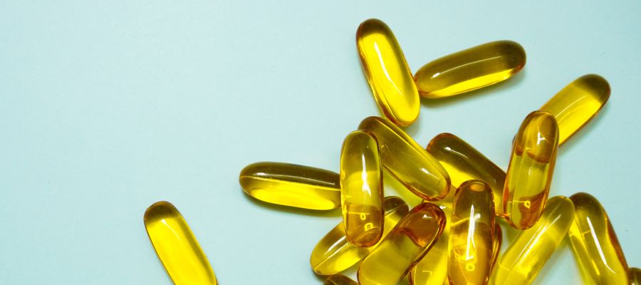 fish oil capsules against lightly colored background